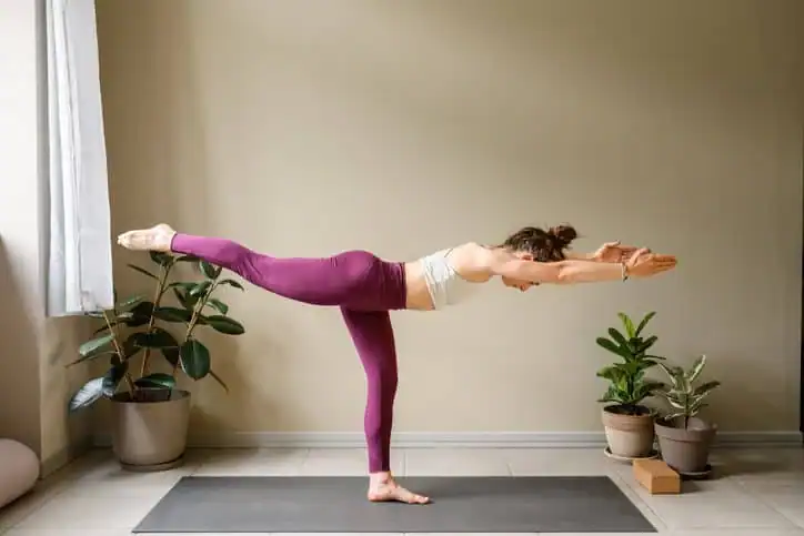 Woman doing Yoga exercise Walton-on-Thames to help with toning the body. 